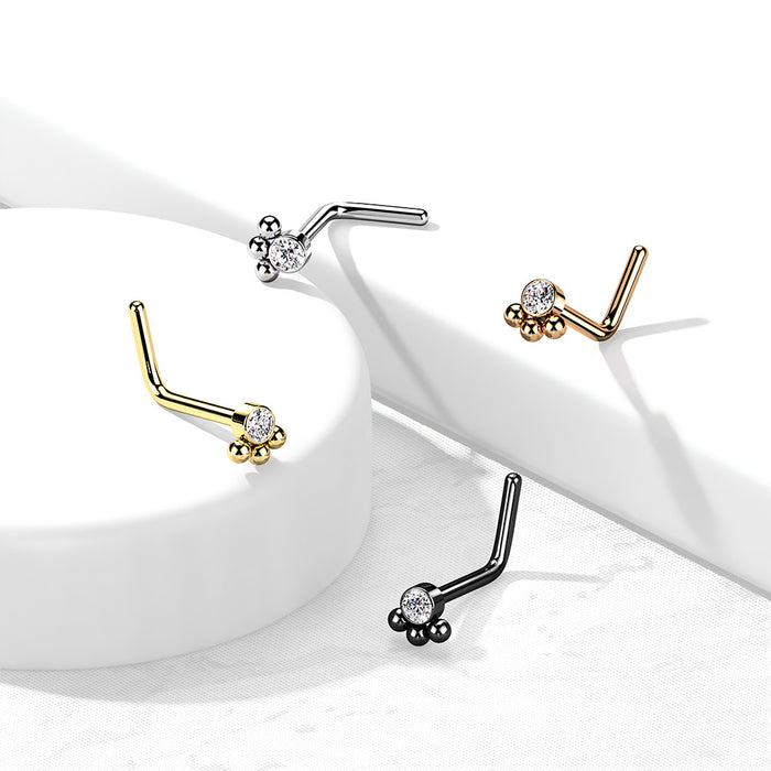 Neuspiercing met een zirconia en drie bolletjes in goud, zilver, rosé en zwart